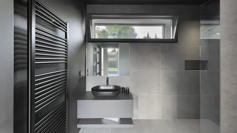 Bagno con rivestimento in gres scuro - Pavimenti in parquet: Villa D.P. - Hausfloor